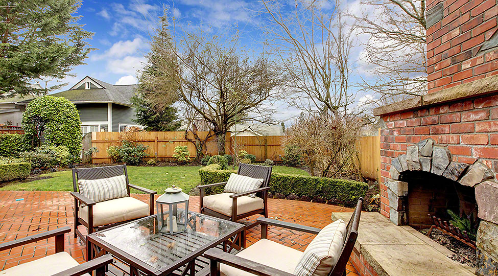 20992717 – spring fenced luxury  backyard with outdoor fireplace and furniture.