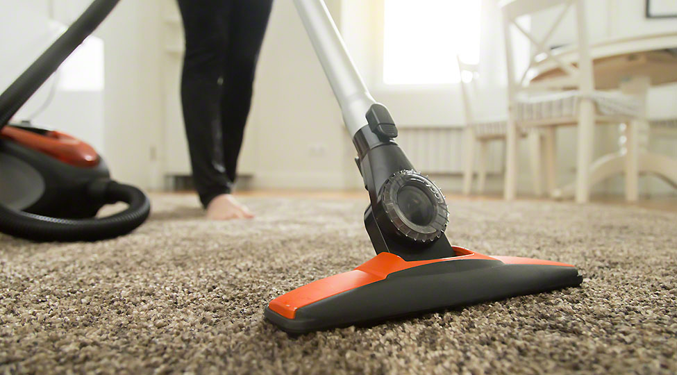 Close up of the vacuum cleaner brush on the carpet
