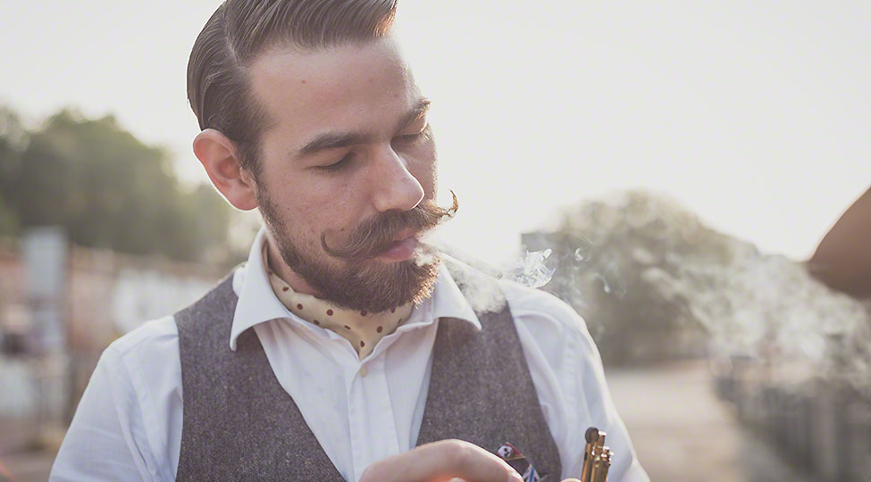 handsome big moustache hipster man smoking cigarette