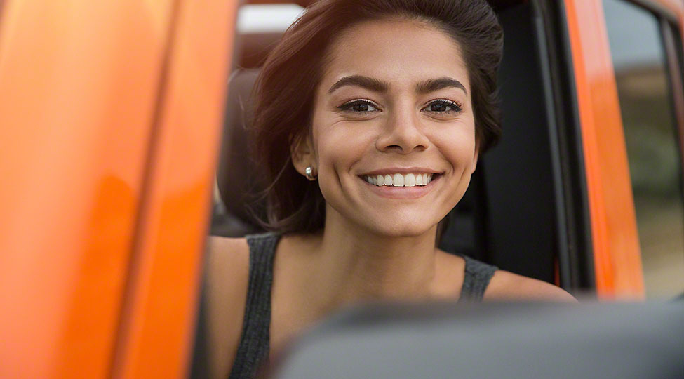 Happy smiling woman driving a jeep
