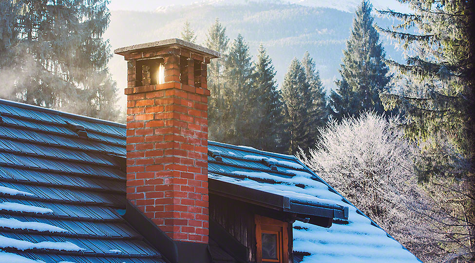 Mountain cottage chimney in winter