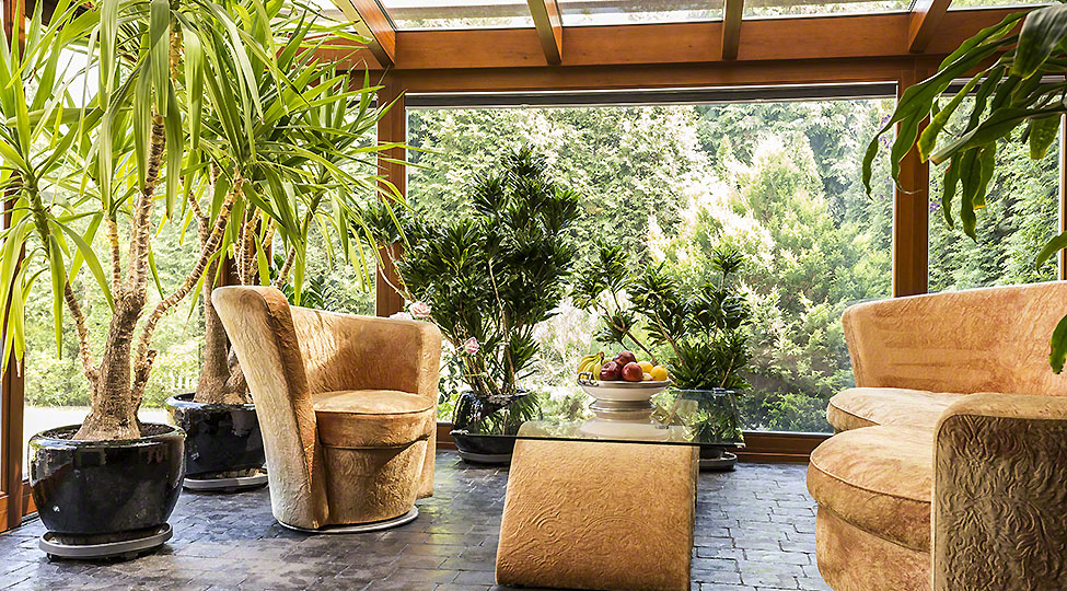 Spacious indoor orangerie with upholstered furniture