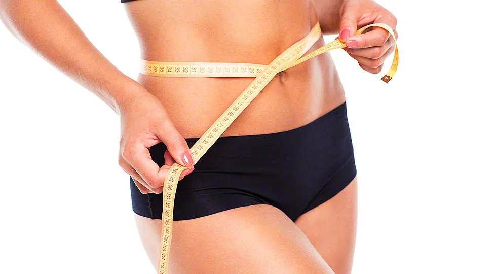 Woman measuring perfect shape of beautiful thigh
