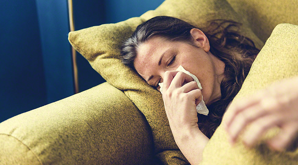 Woman sick on the sofa