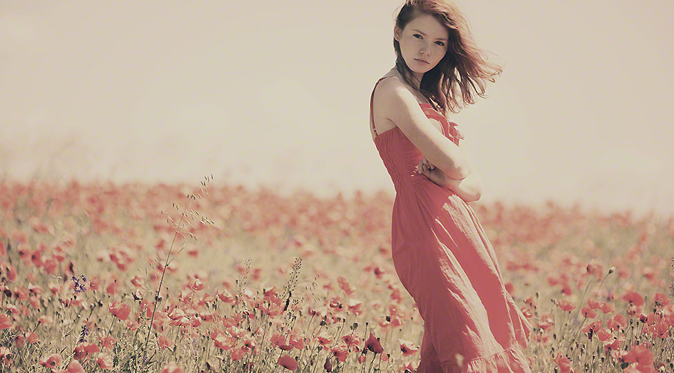young beautiful girl in poppy field